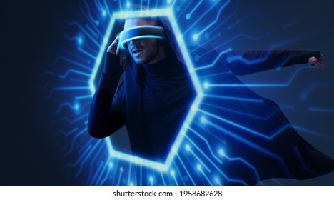 Man on dark virtual reality background. Guy using VR helmet. Augmented reality, future technology, game concept. Blue neon light. Futuristic holographic interface to display data.