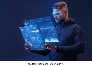 Man On Dark Virtual Reality Background. Guy Using VR Helmet. Augmented Reality, Future Technology, Game Concept. Blue Neon Light. Futuristic Holographic Interface To Display Data.