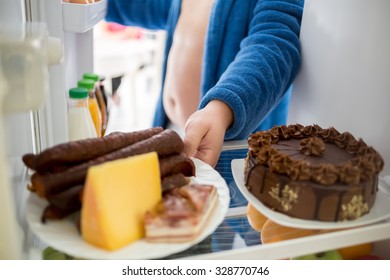 Man On Diet Break Decision And Take Plate Full Of Hard High Calories Food From Fridge