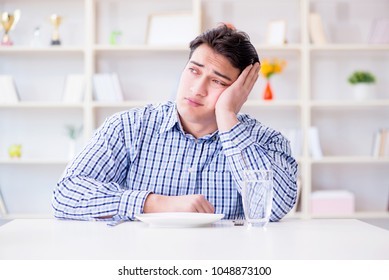 Man On Diet Waiting For Food In Restaurant