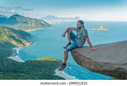 A man on the edge of the abyss. Pedra do Telegrafo is a tourist destination in Rio de Janeiro. Brazil.