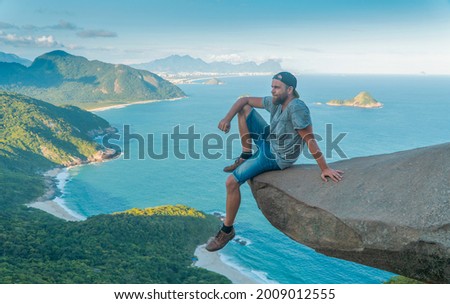 A man on the edge of the abyss. Pedra do Telegrafo is a tourist destination in Rio de Janeiro. Brazil.