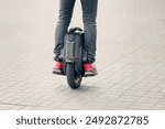 Man on electric wheel riding on sidewalk closeup. Rider