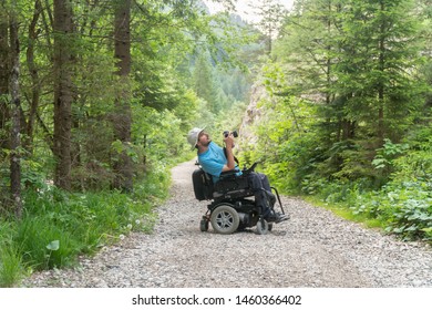 man on electric wheelchair using mirrorless camera nature, enjoying freedom and doing art