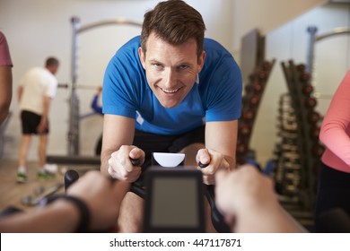 Man On Exercise Bike In A Spinning Class At A Gym, Close Up