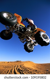 A Man On A Four Wheeler Flying Through The Air