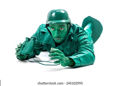 Man On A Green Toy Soldier Costume, Crawling With Binocolous Isolated On White Background.