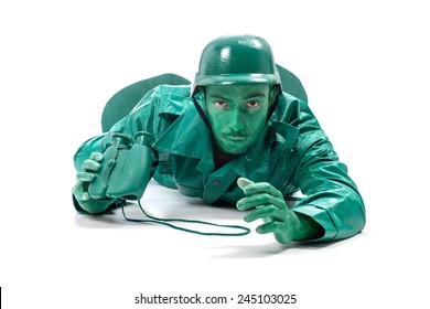 Man On A Green Toy Soldier Costume, Crawling With Binocolous Isolated On White Background.