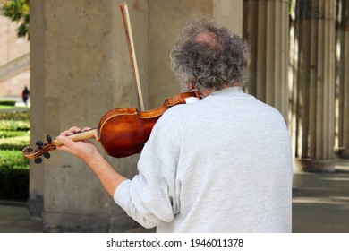 Man On His Back Playing Violin