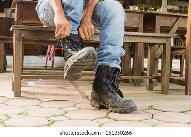 Man On Jeans Is Getting Dressed His Boots