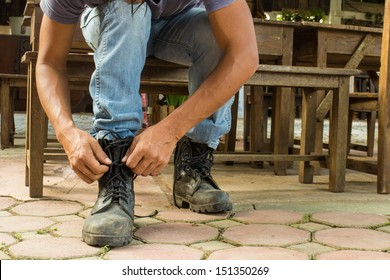 Man On Jeans Is Getting Dressed His Boots