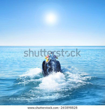 Man on a jet ski fast in the sea at summer time