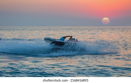 A Man On Jet Ski Jump On The Wave At Amazig Sunset 