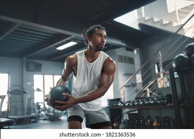 Man On Kettlebell Workout. Sexy Asian Sportsman With Strong, Healthy, Muscular Body Using Heavy Fitness Equipment. Training At Gym For Bodybuilding As Lifestyle.