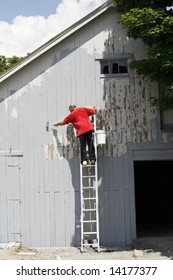 Man On Ladder Painting Barn Wall