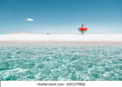 Man on lilo in the sea water. Human relaxing on inflatable ring on the beach. Summer vacations, idyllic scene. - Powered by Shutterstock