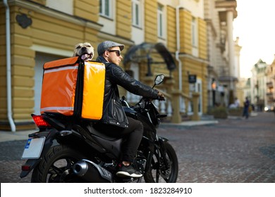 Man On Motorbike With The Dog Inside Special Thermo Bag For Delivery Food On The Street.Food Delivery Service.