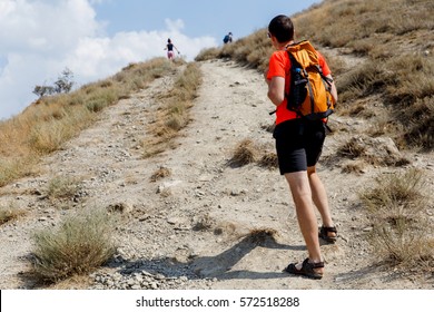 Man on mountain path up