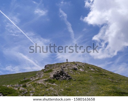 Similar – Image, Stock Photo Four people standing in a row on a ridge (2/2)