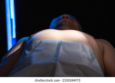 A Man On The Operating Table Before Undergoing Cosmetic Gynecomastia Surgery