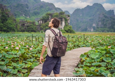 Man on the path among the lotus lake. Mua Cave, Ninh Binh, Vietnam. Vietnam reopens after quarantine Coronovirus COVID 19 concept