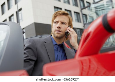 Man On Phone In His Electric Sports Car