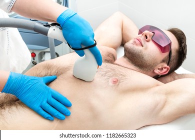 Man on the procedure of laser hair removal in the beauty salon 