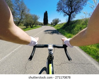 Man On Road Bike In A Tuscany Landscape. POV, Original Point Of View. 