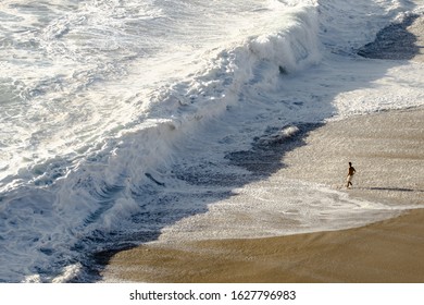 Man On The Shore Break Of Nazare With Big Wave