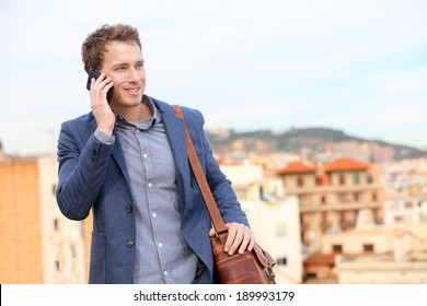 Man On Smartphone - Young Business Man Talking On Smart Phone. Casual Urban Professional Businessman Using Mobile Cell Phone Smiling Happy Walking. Handsome Man Wearing Suit Jacket In Barcelona, Spain