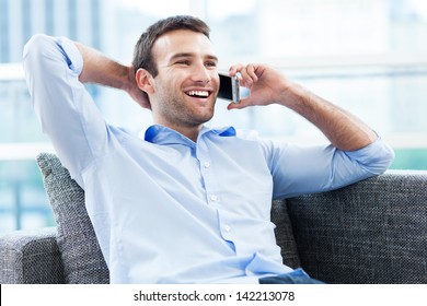 Man On Sofa With Mobile Phone 