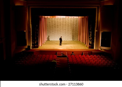 A Man On The Stage In Empty Hall