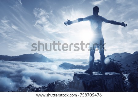 Man on a summit over an ocean of clouds