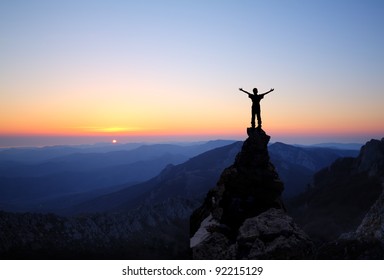 Man On Top Of The Mountain Looking To The Sun