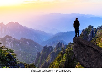 Man on top of mountain,conceptual scene - Powered by Shutterstock