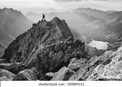 man on the top of the mountains looking to sunset. Black and white photo