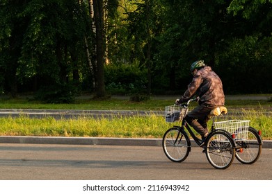 a man on a tricycle against a tree background. High quality photo