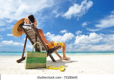 Man On A Tropical Beach With Hat