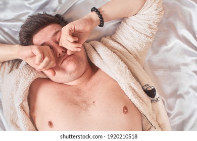 A Man On A White Bed Wakes Up Rubs His Eyes High Key, Close-up