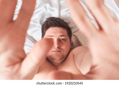 Man On White Bed Wakes Up Stretching High Key, Closeup