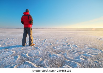 Man On Winter Ice. Hiking Scene.