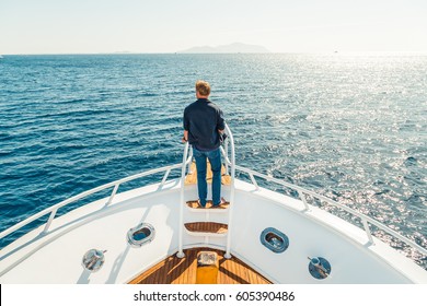 Man On A Yacht. Beautiful View From A Bow Of A Yacht At Seaward. Sailing. Luxury Yachts. Boats In A Sailing Regatta. Summer Vacation And Voyage Concept