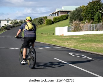 Man On In Yellow Helmet On Black Mountain Bike. Stock Photo. Auckland, New Zealand - June 4, 2022