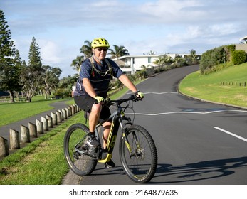 Man On In Yellow Helmet On Black Mountain Bike. Stock Photo. Auckland, New Zealand - June 4, 2022