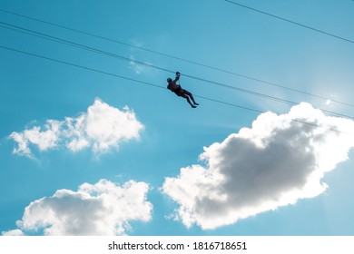 Man On Zipline Ride High In The Sky. Extreme Entertainment.