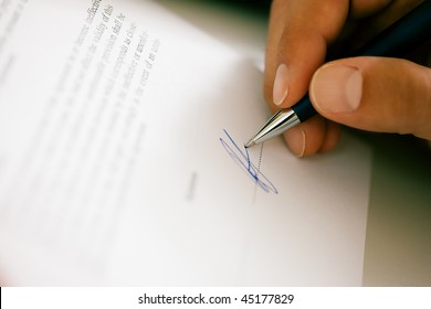 Man (only Hand To Be Seen) Signing A Contract Or Another Document (fake Signature, Focus On Pen)