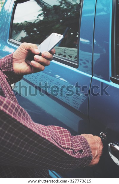 Man open the door car\
with smart phone