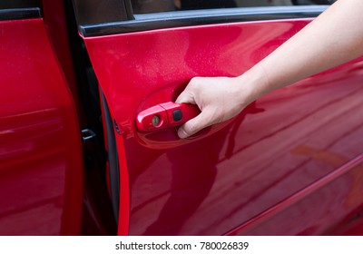 The Man Open The Red Car Door. Check In The Car And Clean.