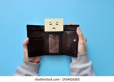 The Man Opened His Wallet And Instead Of Money - A Sad Face. Symbol Of No Money