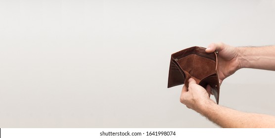 a man opened and holds an empty wallet in his hands